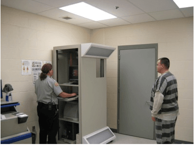 Correction Officer Lisa Vasey Photographs an Inmate Via the New Commonwealth Photo Imaging Network